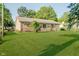 The backyard of this brick home features well-maintained lawn perfect for outdoor activities and relaxation at 450 W 250 N, Lebanon, IN 46052