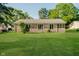 The backyard of this brick home features well-maintained lawn perfect for outdoor activities and relaxation at 450 W 250 N, Lebanon, IN 46052
