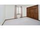 Bright bedroom featuring a window with curtains, carpeted floor, and a closet with paneled doors at 450 W 250 N, Lebanon, IN 46052