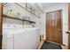 Functional laundry room with washer, dryer, and storage shelving at 450 W 250 N, Lebanon, IN 46052