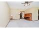 Bright living room featuring neutral carpeting, ceiling fan, and a vintage upright piano at 450 W 250 N, Lebanon, IN 46052