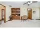 Comfortable living room featuring neutral carpet, built-in shelving, and a ceiling fan at 450 W 250 N, Lebanon, IN 46052