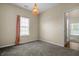 This bedroom features a carpeted floor, window with blinds, and modern light fixture at 452 Southern Pines Dr, Whiteland, IN 46184