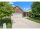 Charming brick home with well-maintained lawn, long driveway, and attached two-car garage at 452 Southern Pines Dr, Whiteland, IN 46184