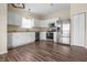 Bright kitchen featuring white cabinets, stainless steel appliances, and wood-look flooring at 452 Southern Pines Dr, Whiteland, IN 46184