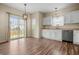Eat-in kitchen with white cabinets, stainless steel appliances, and sliding glass door to the backyard at 452 Southern Pines Dr, Whiteland, IN 46184