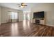 Bright living room with wood-look flooring and plenty of natural light at 452 Southern Pines Dr, Whiteland, IN 46184