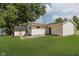 The backyard offers plenty of green space, privacy, and mature trees at 5134 Rinehart Ave, Indianapolis, IN 46241