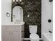 Renovated bathroom with chic wallpaper, elegant vanity and modern fixtures at 5134 Rinehart Ave, Indianapolis, IN 46241