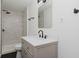 Beautiful bathroom features modern fixtures, vanity, mirror, and walk in shower with elegant tiling at 5134 Rinehart Ave, Indianapolis, IN 46241