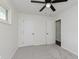 This room offers neutral walls, a ceiling fan, and easy access to other parts of the house at 5134 Rinehart Ave, Indianapolis, IN 46241