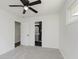 This bedroom has neutral walls and carpet, with a ceiling fan and bathroom access at 5134 Rinehart Ave, Indianapolis, IN 46241