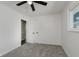 Bedroom with neutral walls, carpeting, a ceiling fan, and closet space at 5134 Rinehart Ave, Indianapolis, IN 46241