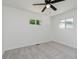 Bright bedroom featuring plush carpet, ceiling fan, and double windows at 5134 Rinehart Ave, Indianapolis, IN 46241