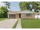 Charming single-story home with stone facade, attached garage, and well-maintained lawn at 5134 Rinehart Ave, Indianapolis, IN 46241