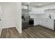 Bright kitchen features white cabinets, stainless steel appliances, and wood-look flooring at 5134 Rinehart Ave, Indianapolis, IN 46241