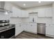 Modern kitchen boasts white cabinets, stainless steel appliances, and sleek countertops at 5134 Rinehart Ave, Indianapolis, IN 46241