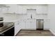 Modern kitchen boasts white cabinets, stainless steel appliances, and sleek countertops at 5134 Rinehart Ave, Indianapolis, IN 46241