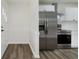 Bright kitchen features white cabinets, stainless steel appliances, and wood-look flooring at 5134 Rinehart Ave, Indianapolis, IN 46241