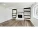 Cozy living room offering fireplace, built-in shelving and luxury vinyl plank flooring at 5134 Rinehart Ave, Indianapolis, IN 46241