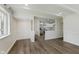 Open-concept living room featuring luxury vinyl plank flooring and opening to kitchen at 5134 Rinehart Ave, Indianapolis, IN 46241
