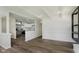 Open-concept living room featuring wood floors and opening to kitchen with stainless steel appliances at 5134 Rinehart Ave, Indianapolis, IN 46241
