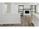 An open living room with fireplace, built-in shelves and luxury vinyl plank flooring at 5134 Rinehart Ave, Indianapolis, IN 46241