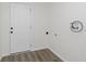 This clean mud room features new flooring and a door to the exterior at 5134 Rinehart Ave, Indianapolis, IN 46241