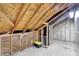 A spacious unfinished attic with exposed beams, insulation, and storage possibilities at 5225 Thompson Park, Indianapolis, IN 46237