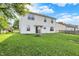 Well-maintained backyard with a fire pit, lush green grass, and access to the home through sliding glass doors at 5225 Thompson Park, Indianapolis, IN 46237