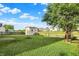 Scenic backyard featuring a pond view, picnic table, shed, and fire pit area, perfect for outdoor enjoyment at 5225 Thompson Park, Indianapolis, IN 46237