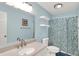 Full bathroom with a decorative mirror and blue droplet shower curtain at 5225 Thompson Park, Indianapolis, IN 46237