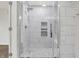 Bathroom featuring a glass-enclosed shower with white tiles and decorative stone accents, creating a spa-like feel at 5225 Thompson Park, Indianapolis, IN 46237
