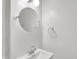 Bathroom featuring a modern sink with chrome fixtures and a round mirror at 5225 Thompson Park, Indianapolis, IN 46237