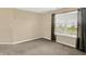 Bright bedroom with neutral walls, carpet, and a large window with neighborhood view at 5225 Thompson Park, Indianapolis, IN 46237