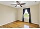 Bedroom with hardwood flooring, neutral walls, and a window overlooking a lake at 5225 Thompson Park, Indianapolis, IN 46237