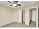 Comfortable bedroom with soft carpet, ceiling fan, and easy access to closet space at 5225 Thompson Park, Indianapolis, IN 46237