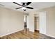 Bright bedroom with hardwood floors, ceiling fan, closet, and neutral wall paint at 5225 Thompson Park, Indianapolis, IN 46237