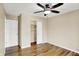Bedroom with hardwood flooring, neutral walls, closet, and two entry doors at 5225 Thompson Park, Indianapolis, IN 46237