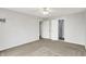 Bright bedroom with neutral carpet, a ceiling fan, and doorways to an ensuite bathroom and closet at 5225 Thompson Park, Indianapolis, IN 46237