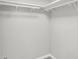 Empty walk-in closet with white shelves and racks, providing ample storage space for clothing and accessories at 5225 Thompson Park, Indianapolis, IN 46237