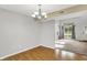 Bright dining room featuring wood floors and a decorative chandelier fixture at 5225 Thompson Park, Indianapolis, IN 46237