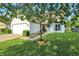 Well-manicured lawn and shrubbery surrounding the exterior of a charming single Gathering home at 5225 Thompson Park, Indianapolis, IN 46237
