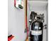 A neat garage corner shows an air compressor and shelving for tools at 5225 Thompson Park, Indianapolis, IN 46237