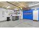 A large garage space with work counter, bright lighting, and painted accent wall at 5225 Thompson Park, Indianapolis, IN 46237