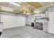 A spacious garage has work counter space, storage options, and bright lighting at 5225 Thompson Park, Indianapolis, IN 46237