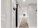Hallway with neutral paint and carpet, leading to a living room with a fireplace and ample lighting at 5225 Thompson Park, Indianapolis, IN 46237