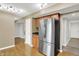 Open concept kitchen with wood floors and stainless steel refrigerator at 5225 Thompson Park, Indianapolis, IN 46237