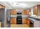 Bright kitchen featuring wood cabinets and stainless steel appliances at 5225 Thompson Park, Indianapolis, IN 46237