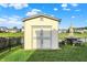 Backyard shed complete with picnic table and umbrella set next to a pond, offering a serene outdoor space at 5225 Thompson Park, Indianapolis, IN 46237